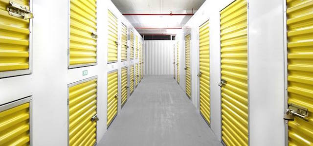 An interior view of Ben Hur Moving & Storage's bright yellow storage rooms with bright lights.